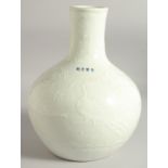 A CHINESE WHITE GLAZE CARVED FLOWER VASE, bearing four-character mark, 28.5cm high.