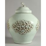 A LARGE CHINESE YUAN STYLE URN AND COVER, with relief floral panels and incised decoration, the