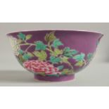 A CHINESE PURPLE GROUND FAMILLE ROSE BOWL, with enamel painted floral decoration, character mark