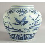 A LARGE CHINESE BLUE AND WHITE PORCELAIN JARDINIERE, painted with birds and flora, bearing a four-