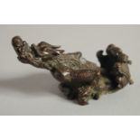 A JAPANESE BRONZE OKIMONO of a mythical beast, with six-character mark to base, 8.5cm long.