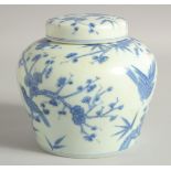 A CHINESE BLUE AND WHITE PORCELAIN JAR AND COVER, with birds and flora, 13cm high.