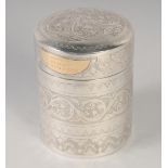 A FINELY ENGRAVED MALAY SILVER CYLINDER BOX; gifted by the sultan of Brunei, with gold plaque,