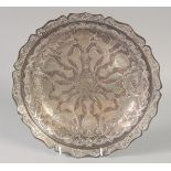 A FINE ISLAMIC SILVER INLAID DISH, with engraved decoration and calligraphic inscriptions, 28cm