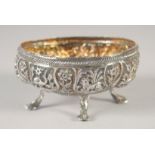 AN EMBOSSED AND CHASED SILVER OVAL FORM BOWL, decorated with panels of animals and flora, raised