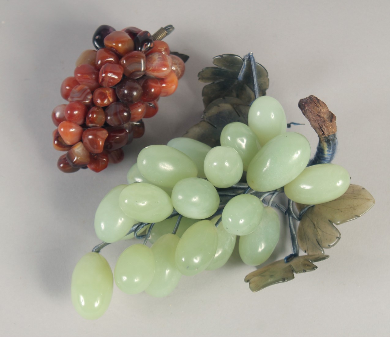 TWO SETS OF HARDSTONE GRAPES, one jade, the other with agate, (2).