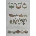 A RARE COLLECTION OF THIRTY 12TH-13TH CENTURY PERSIAN SELJUK BRONZE PENDANTS and other jewellery