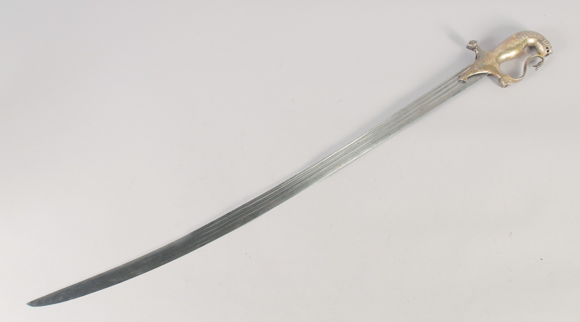 A SOUTH INDIAN MAYSORE SWORD, with single edge blade cut with three narrow fullers, silver gilt hilt