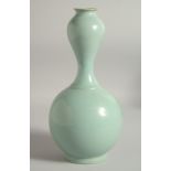 AN UNUSUAL CHINESE CELADON VASE, 30.5cm high.