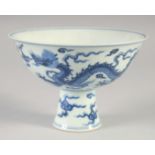 A CHINESE BLUE AND WHITE PORCELAIN STEM CUP, decorated with dragons and stylised clouds, the base