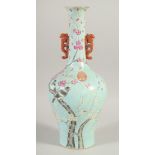 A CHINESE BLUE GROUND PORCELAIN TWIN HANDLE VASE, decorated with birds on a branch, four-character