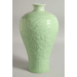 A RARE CHINESE CELADON GLAZE CARVED DRAGON VASE, the relief decoration with dragons surrounding