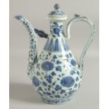 A CHINESE MING STYLE BLUE AND WHITE PORCELAIN LIDDED WINE POT, with floral decoration, 30cm high.