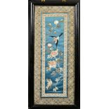 A CHINESE TEXTILE PANEL, framed and glazed, textile 58.5cm x 23.5cm.