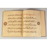 A 20TH CENTURY EASTERN BOUND KUFIC SCRIPT JUZ FROM THE QURAN, 30cm x 25cm.