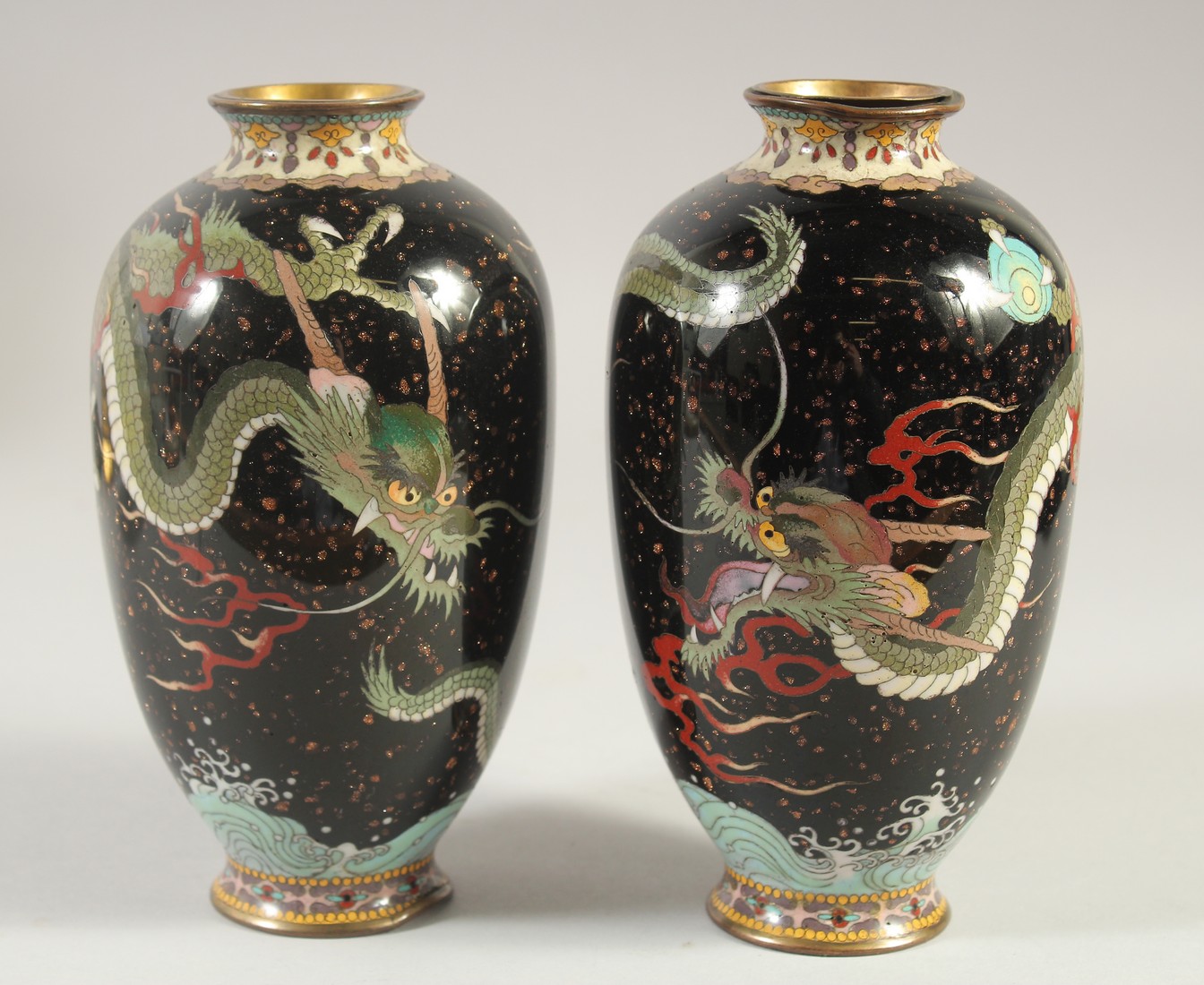 A PAIR OF CHINESE CLOISONNE DRAGON VASES, 18cm high.