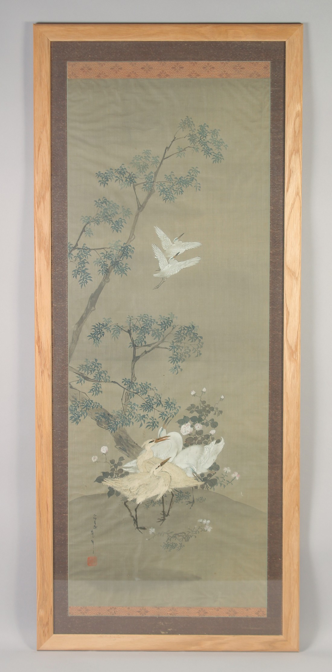 A 19TH CENTURY FRAMED JAPANESE SCROLL PAINTING ON SILK, depicting cranes - with two embroidered
