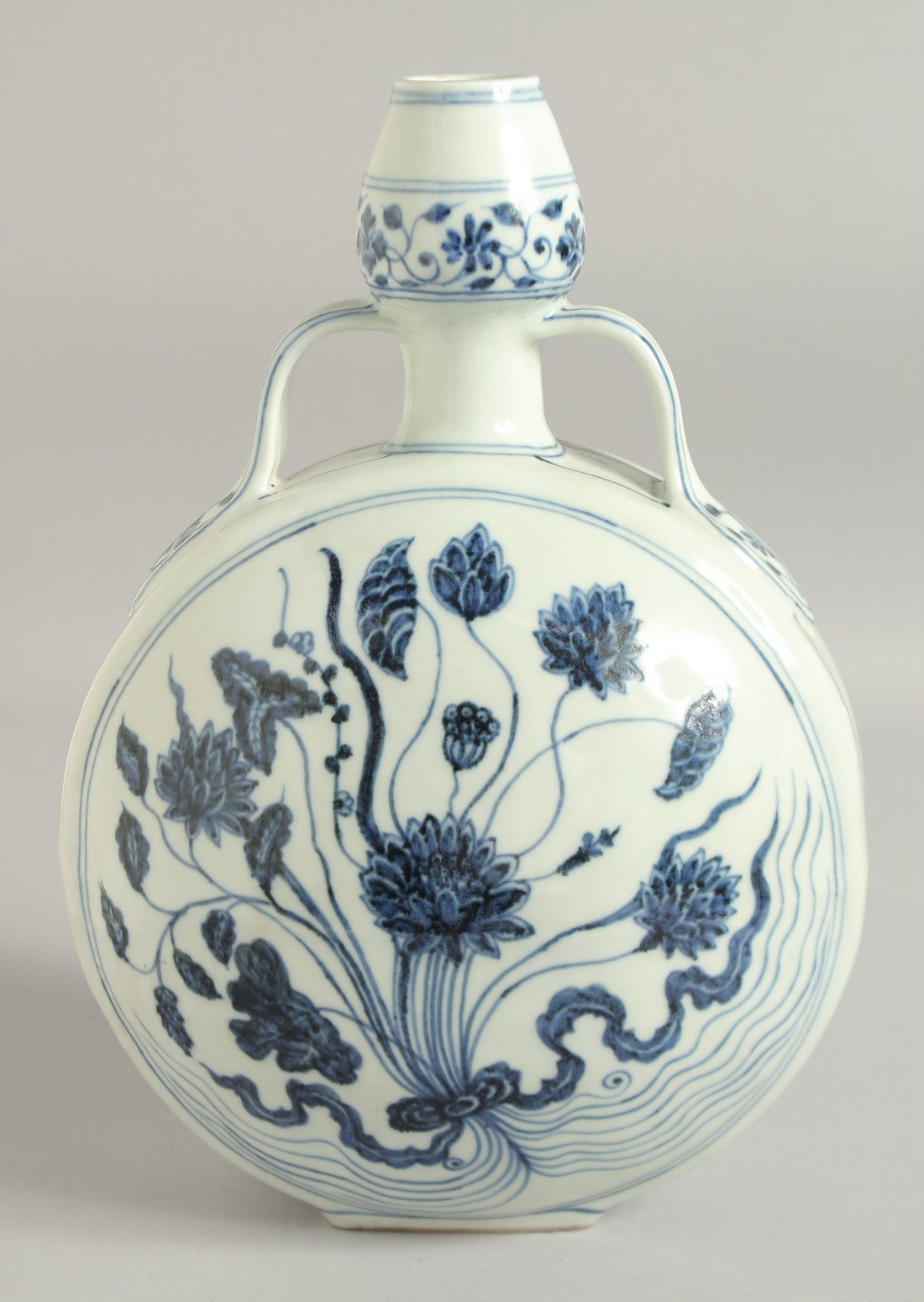 A CHINESE BLUE AND WHITE TWIN HANDLE MOON FLASK, with central floral spray, 30cm high.