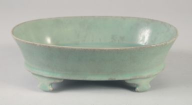 A CHINESE RU WARE STYLE OVAL FORM PLANTER, raised on four feet, 22.5cm wide.