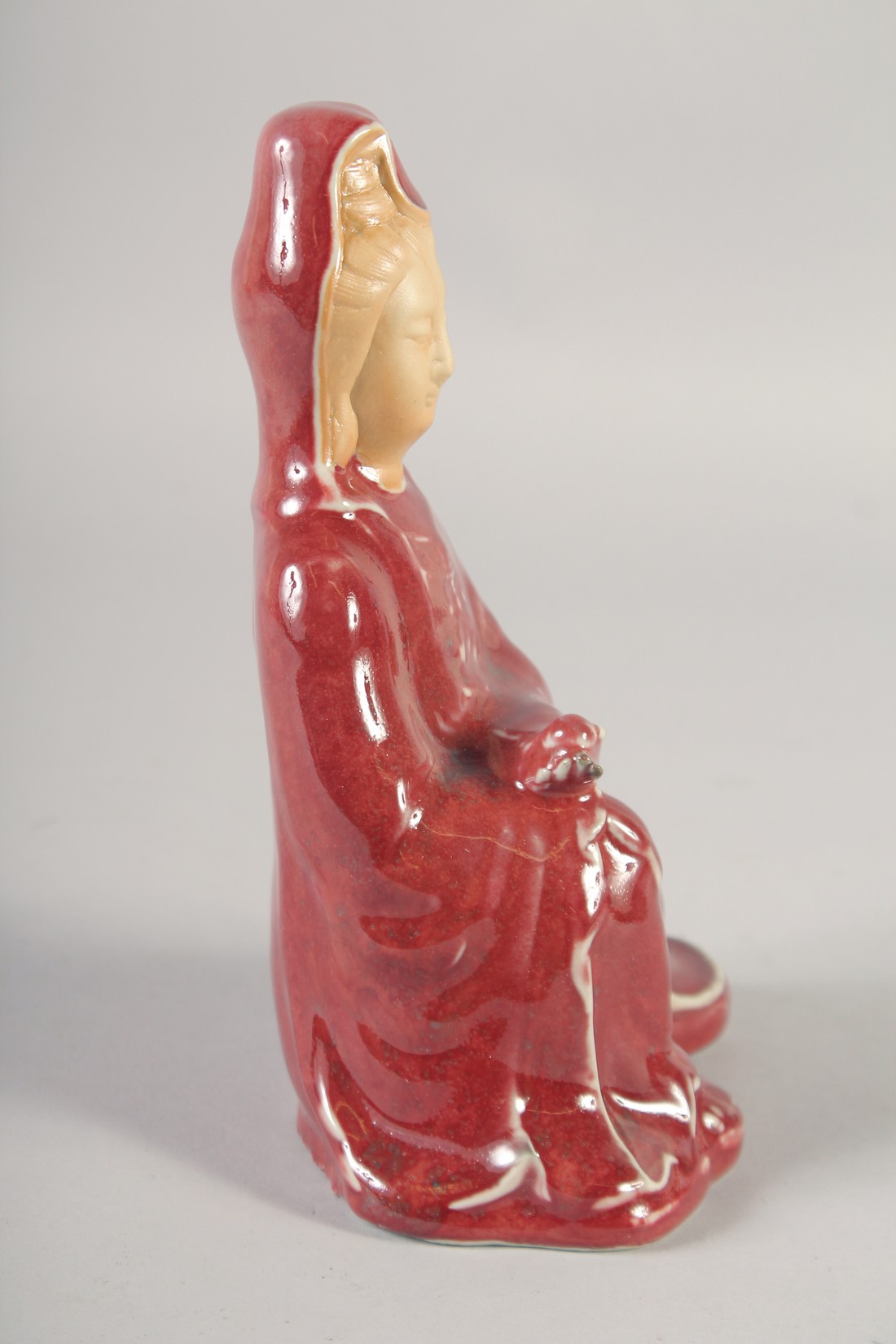 A CHINESE COPPER RED GLAZE PORCELAIN FIGURE, 21cm high. - Image 2 of 6