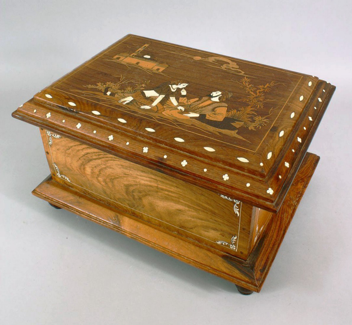 AN INDIAN BONE INLAID WOODEN BOX, inlaid with romantic figures in a landscape, with inlaid border
