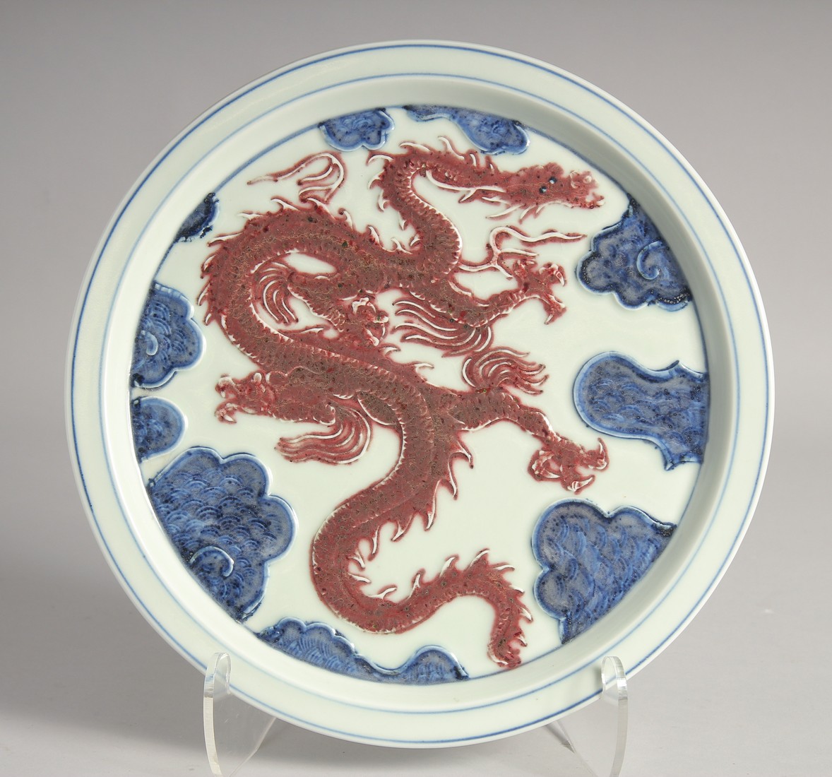 A CHINESE BLUE AND UNDERGLAZE RED PORCELAIN DRAGON DISH, 30cm diameter.