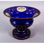 A 19TH CENTURY ENAMEL BLUE BOHEMIAN GLASS TAZZA, with enamel floral panel & gilt decoration, 16cm