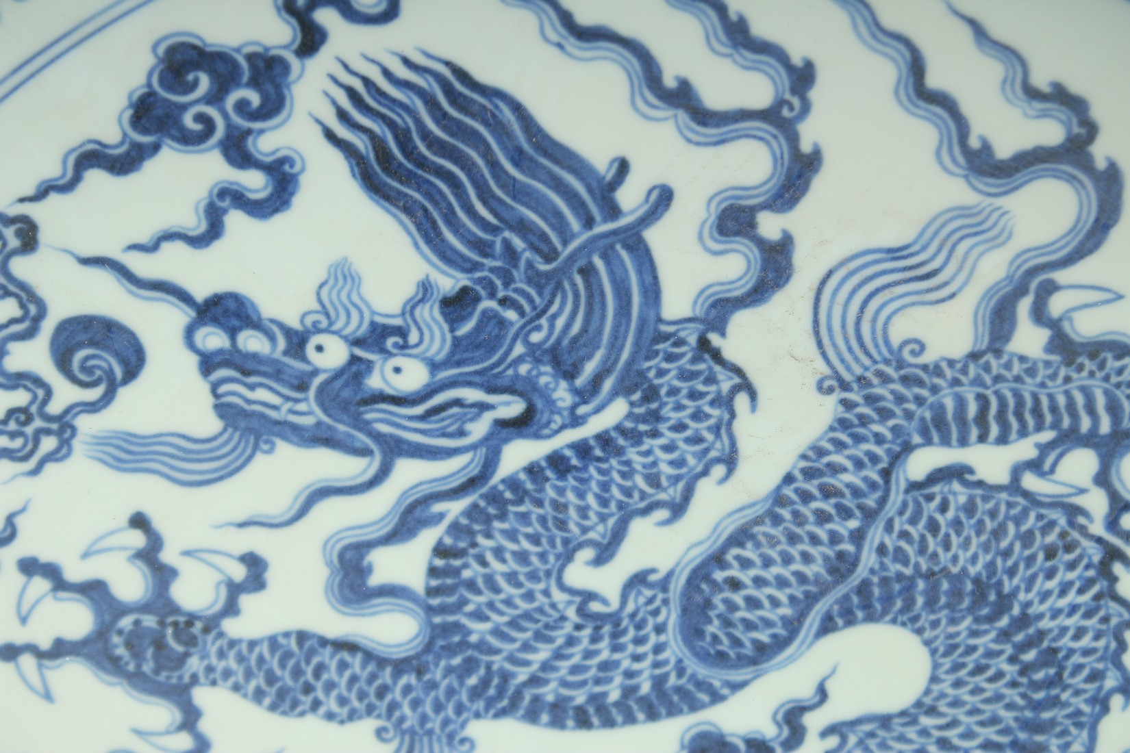 A VERY LARGE CHINESE BLUE AND WHITE PORCELAIN DRAGON DISH, with a large central dragon and the - Image 2 of 3