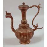 AN ISLAMIC BRONZE EWER. 9ins high.