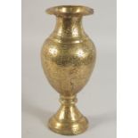 AN INDIAN ENGRAVED AND CHASED BRASS VASE, 24cm high.