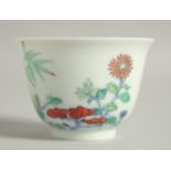 A CHINESE DOUCAI PORCELAIN CUP, with floral decoration and six-character mark, 6cm diameter.