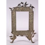 AN ISLAMIC PERSIAN STYLE WHITE METAL PICTURE FRAME, with decoration of ram, 19.5cm x 12cm.