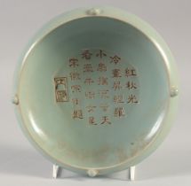 A CHINESE CELADON BOWL, with incised calligraphy, 19cm diameter.