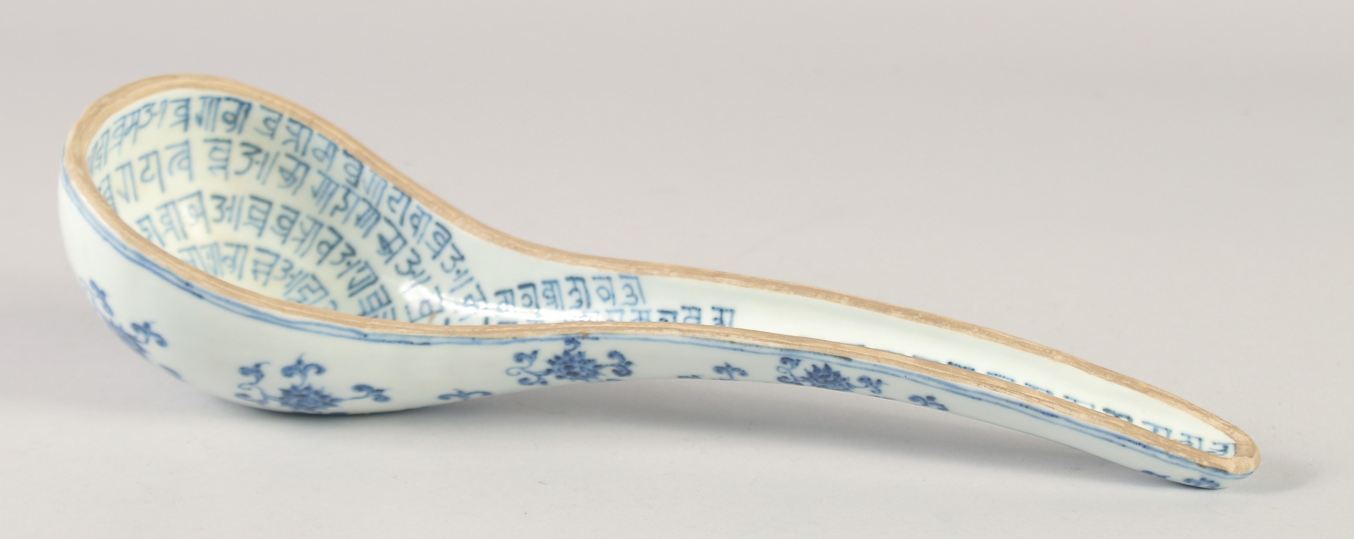 A LARGE CHINESE BLUE AND WHITE PORCELAIN LADLE, the interior with characters, bearing six-