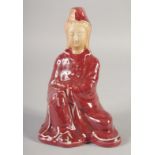 A CHINESE COPPER RED GLAZE PORCELAIN FIGURE, 21cm high.