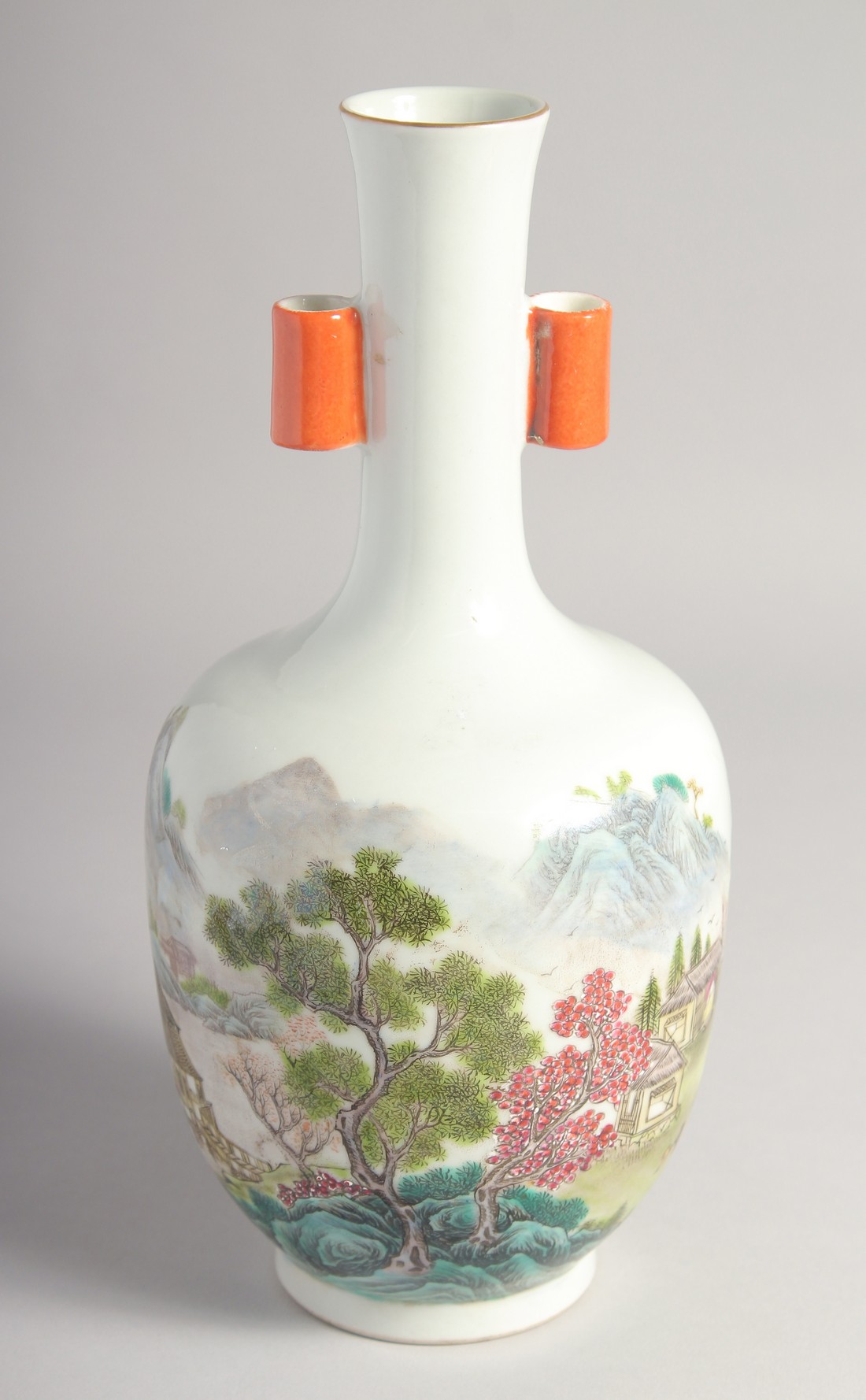 A CHINESE FAMILLE ROSE TWIN HANDLE VASE, painted with a mountainous landscape, the base with six-