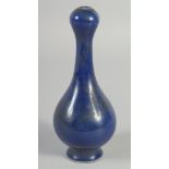 A SMALL BLUE CHINESE GARLIC NECK PORCELAIN VASE. 7ins high.