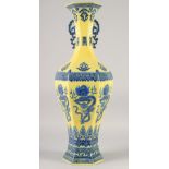 A LARGE CHINESE YELLOW GROUND BLUE AND WHITE HEXAGONAL VASE, with molded twin handles, 58cm high.