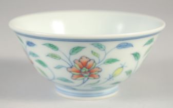 A CHINESE DOUCAI PORCELAIN CUP, with floral decoration, six-character mark to base, 9cm diameter.