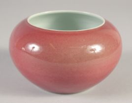 A CHINESE COPPER RED PORCELAIN BRUSH WASHER, 14cm diameter.