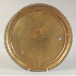 AN ENGRAVED BRASS DISH, with floral decoration, 29.5cm diameter.