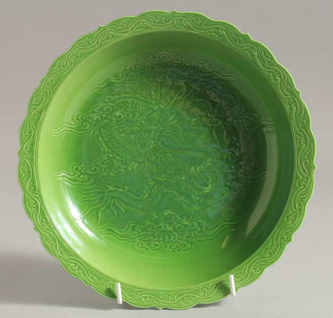 A CHINESE GREEN GLAZE PORCELAIN DISH, with incised dragon to the centre, character mark to base.