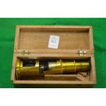 A boxed brass microscope.