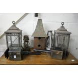 A pair of candle lanterns, an unusual copper roofed bird box and items.