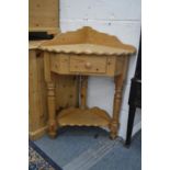 A pine corner washstand.