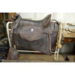 A leather gaucho saddle complete with set of bolas.