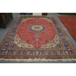 A good large Persian design carpet, red ground with floral decoration 340cm x 255cm.