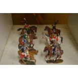 Six painted cast metal military figures on horseback.