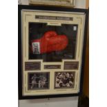 A Sugar Ray Leonard signed boxing glove mounted in a display case with associated material.