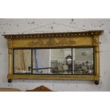 A Regency gilt framed oval mantle mirror.